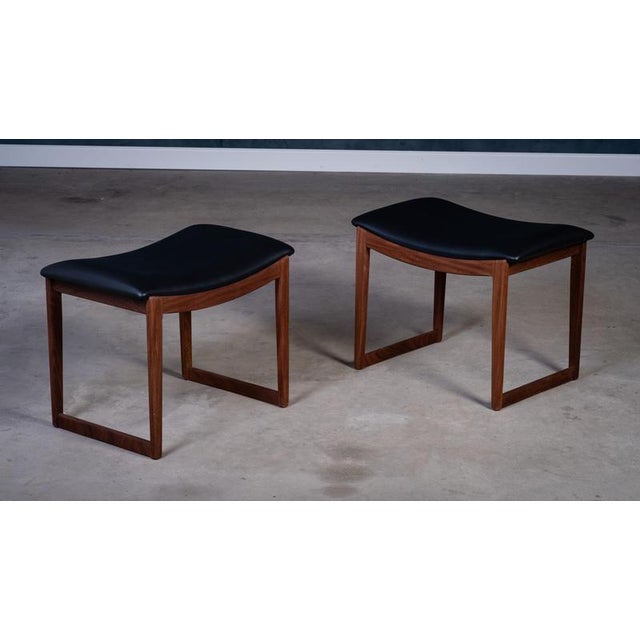 Elegant pair of Danish mid-century stools from the 1960s, crafted in solid teak wood. Fully restored and upholstered with...