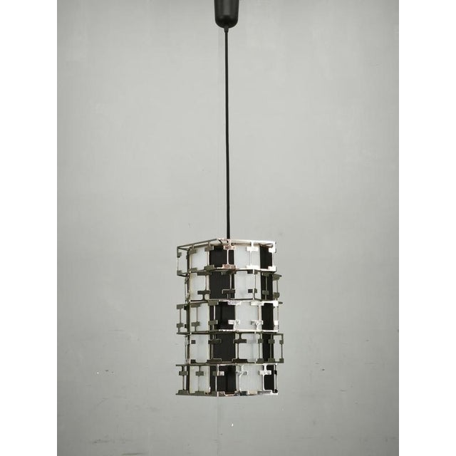 Exceptional mid-century modern pendant light produced in czechoslovakia during the 1960s. The fixture features an...