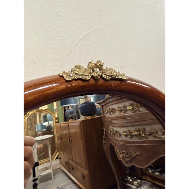Beautiful cherrywood framed mirror with brass detailing in a distinctive keyhole shape. Elegant Art Nouveau styling, rich...