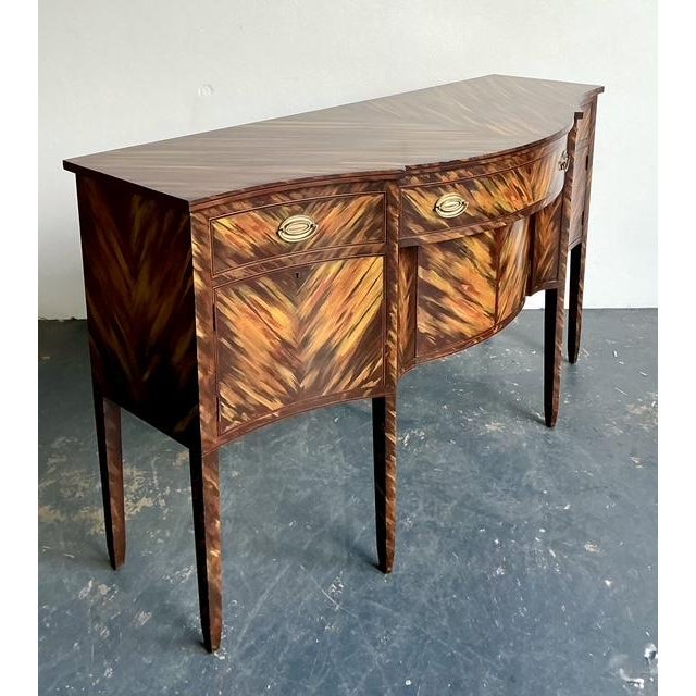 This exceptional serpentine sideboard is a masterclass in artisanal finishing and classic Federal-period form, crafted by...