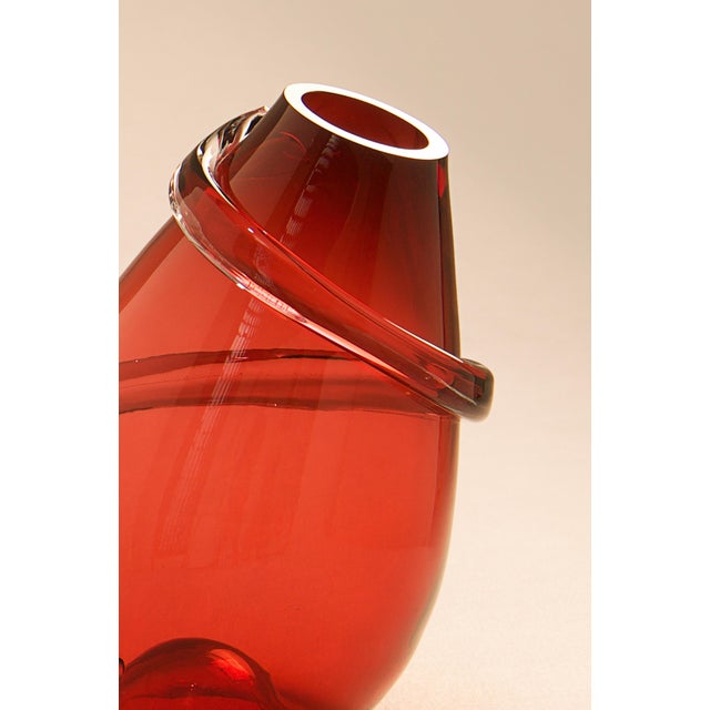 A vase in red glass, created by artist Sem Schanzer in the 1990s as part of the artists's collective, l'Anverre. The vase...