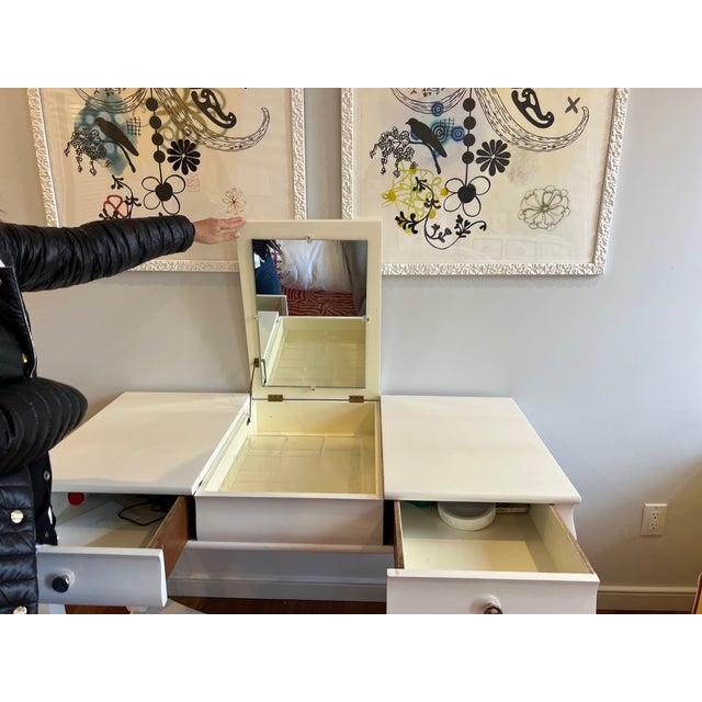 White Dorothy draper style desk in excellent condition with two drawers and vanity top with mirror inset. No information...
