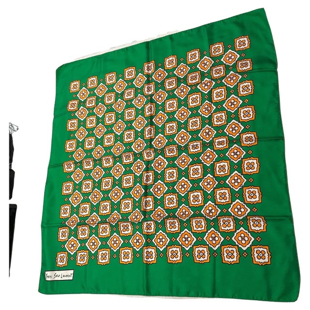 Embrace the bold elegance of the 1990s with this vintage silk carré scarf by Yves Saint Laurent. Featuring a vibrant green...