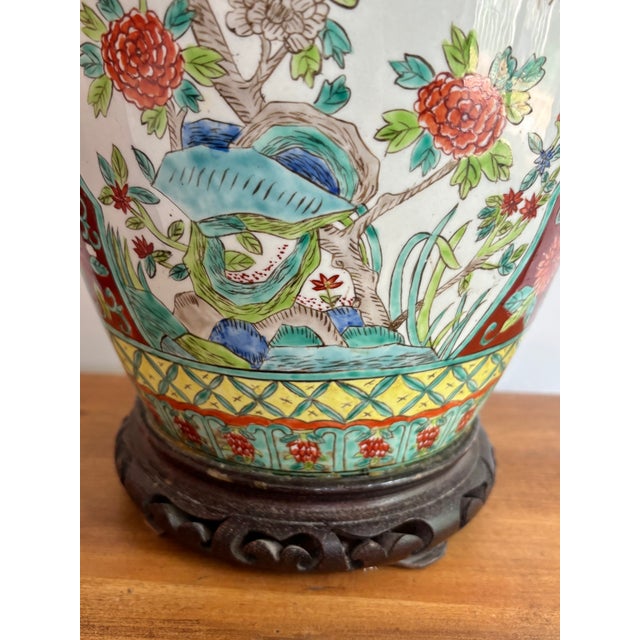 Beautiful ornate Asian midcentury lamp with ornate wood base and cap. Handpainted with a teal and orange bird and...