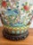 Beautiful ornate Asian midcentury lamp with ornate wood base and cap. Handpainted with a teal and orange bird and...