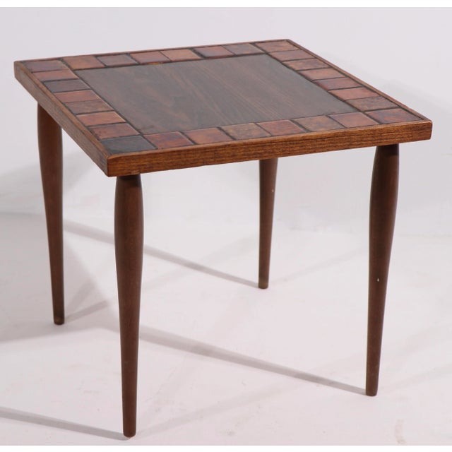 Set of three stacking tables, with wood legs, tile and formica tops. Classic Mid Century form, good original condition,...