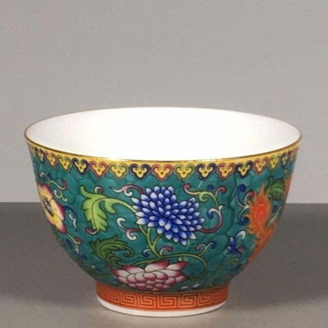 This is a striking vintage porcelain teabowl, decorated in the famille rose palette with vibrant polychrome enamels. The...