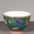 This is a striking vintage porcelain teabowl, decorated in the famille rose palette with vibrant polychrome enamels. The...
