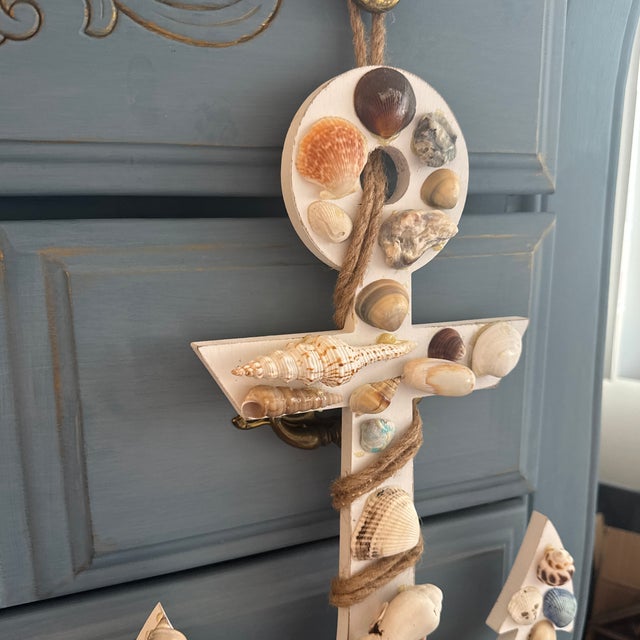 An eye-catching, artisanal coastal folk art wall hanging crafted in the form of a classic ship's anchor. This unique,...