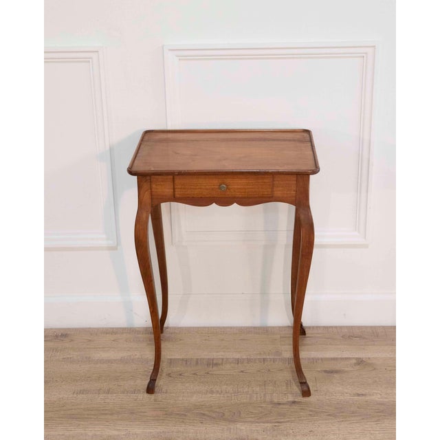 Charming Louis XV–style miniature side table crafted in fruitwood during the early 20th century. The piece reflects the...