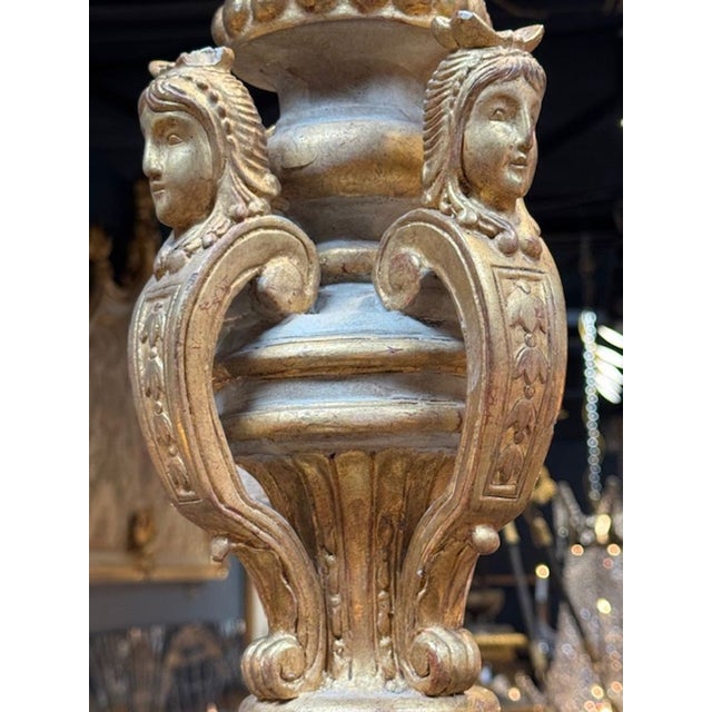 This Antique French Carved and Parcel Gilt 8 Arm Chandelier is a stunning piece of lighting that adds a touch of elegance...