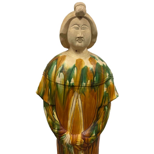 This reproduction of Chinese Sancai glazed pottery figure is a traditional style of ceramic art that flourished during the...