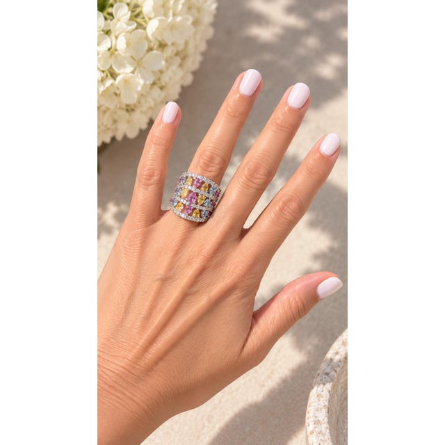 A dazzling Italian 18K white gold statement ring set with a joyful mix of natural pink, yellow, and blue sapphires...