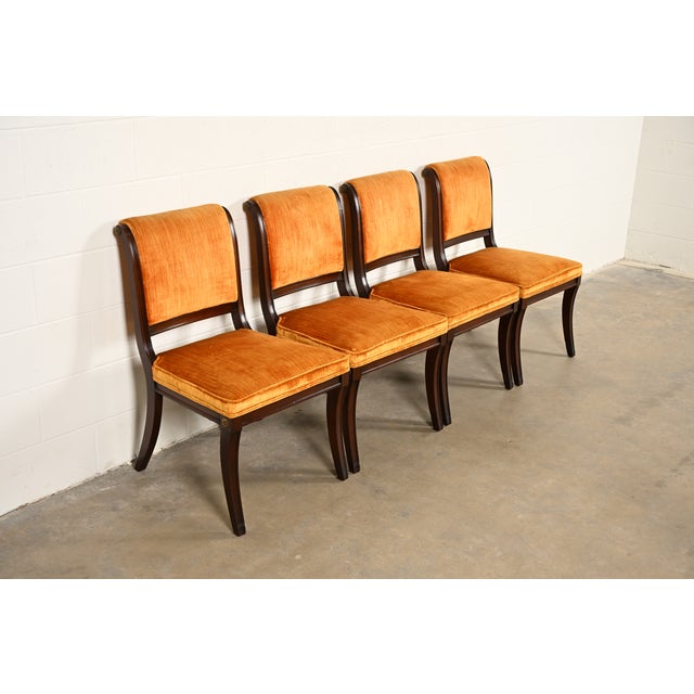 A gorgeous set of four Regency style dining chairs By Kittinger USA, Circa 1960s Carved mahogany frames, with upholstered...