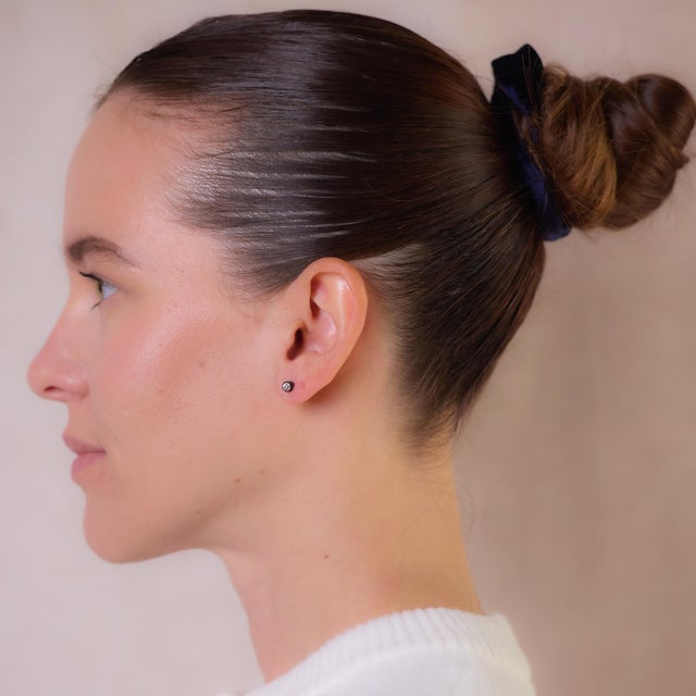 These antique 14k rose gold and silver stud earrings feature two old European cut diamonds totaling approximately 0.50...