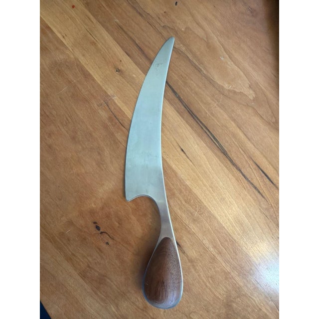 Vintage Dansk Torun cheese knife, mid-century modern design. This iconic piece features a sleek stainless steel curved...