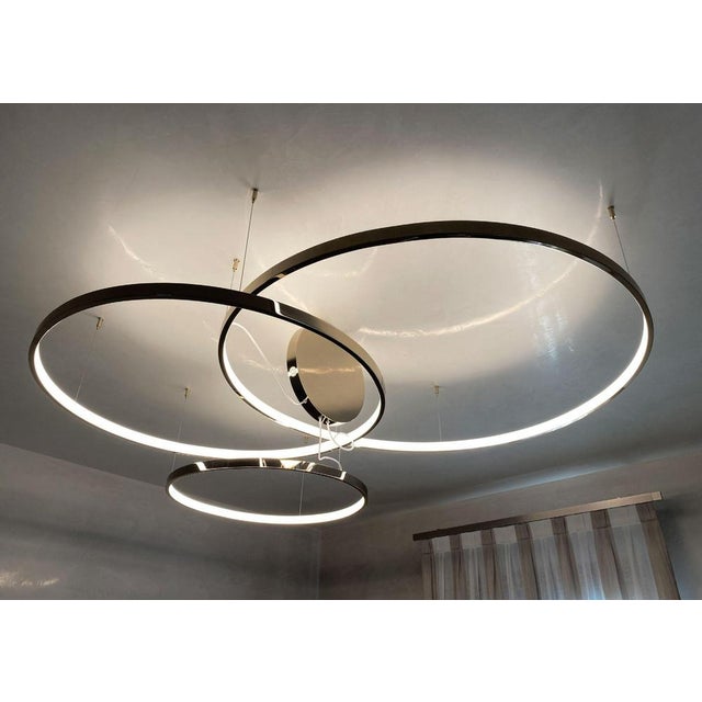 Plumbeo triple ring suspension light in galvanic plumbeo by aggiolight. Dimensions: small ring: d 80 x h 3.5 cm. Medium...