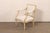 A French Louis XVI style square-back armchair from the Mid 20th century. This vintage chair from France has a square-...