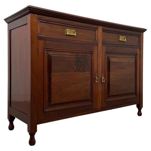 A beautifully crafted early 20th-century English Edwardian sideboard, finely constructed in mahogany and combining elegant...
