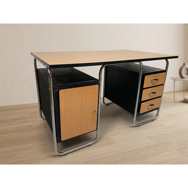 A functional Bauhaus-style desk produced by Torck in Belgium during the 1950s. Defined by its tubular chrome frame and...