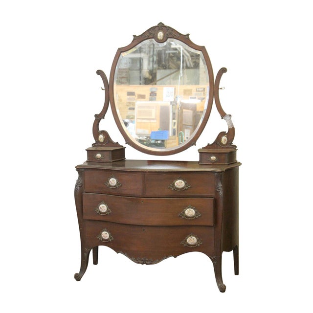 Queen Anne four drawer wooden vanity with additional small drawers built into the original beveled mirror’s arms. Figural...
