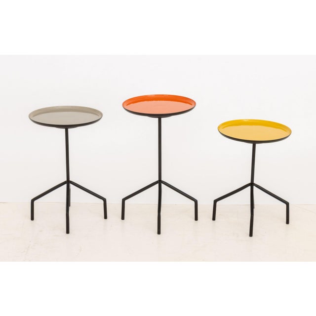 Set of Three Herman Miller Style Enameled Steel Graduated Side Tables, the swivel tops in orange, gray, and yellow....
