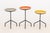 Set of Three Herman Miller Style Enameled Steel Graduated Side Tables, the swivel tops in orange, gray, and yellow....