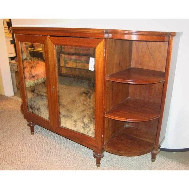 Offered is a 2 door commode with side shelving. This traditional beauty is a great styling piece for your elegant home!