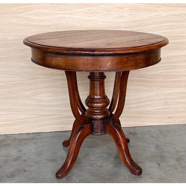 A beautiful finely carved British Colonial wooden circular side table with a pedestal leg. Dimensions: Height: 28.75 in...