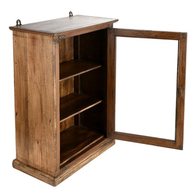 This old solid wood wall display case embodies all the charm and elegance of period furniture. with its clean lines and...