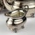 Antique four piece silver plate tea set made in Sheffield, England in the 1930s. Of plain form, on four claw feet, all...