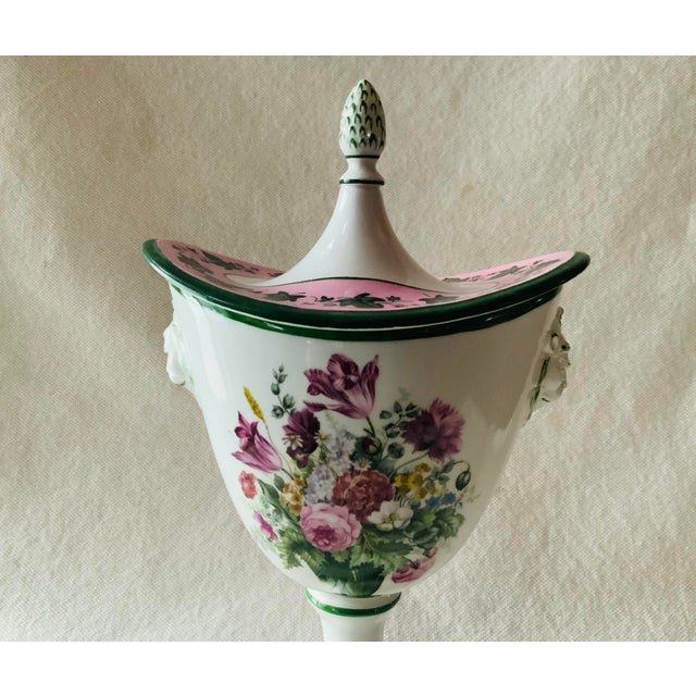 A beautiful Mottahedeh Italian porcelain lidded urn in the neoclassical style. The white body features a large polychrome...