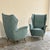 A pair of 1950s armchairs, Italian-made by Isa Ponte San Pietro. The armchairs feature a solid frame upholstered in a...