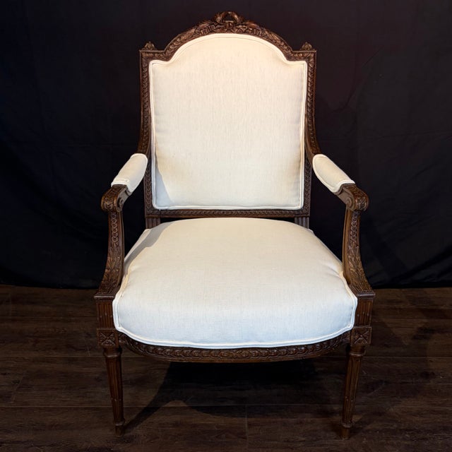 Elegant antique pair of French Louis XVI armchairs or fauteuils, finely hand-carved in richly patinated walnut,...