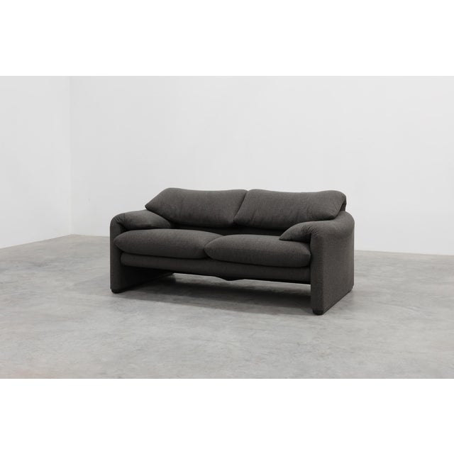 A beautifully proportioned two‑seat sofa designed by Vico Magistretti and produced by Cassina in 1990, reflecting the...