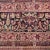 An early 20th Century Persian Kirmanshah carpet with central floral medallion on a cranberry background surrounded by a...