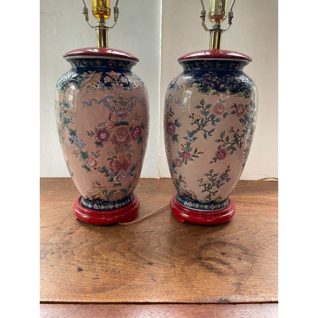 A lovely pair of Chinese Porcelain Ceramic Lamps. The vintage lamps are decorated with a traditional floral pattern, a...