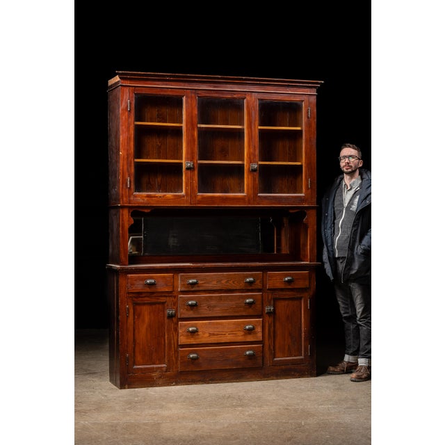 Substantial early 20th-century step-back kitchen hutch constructed from paneled wood and finished in a rich oxblood stain....
