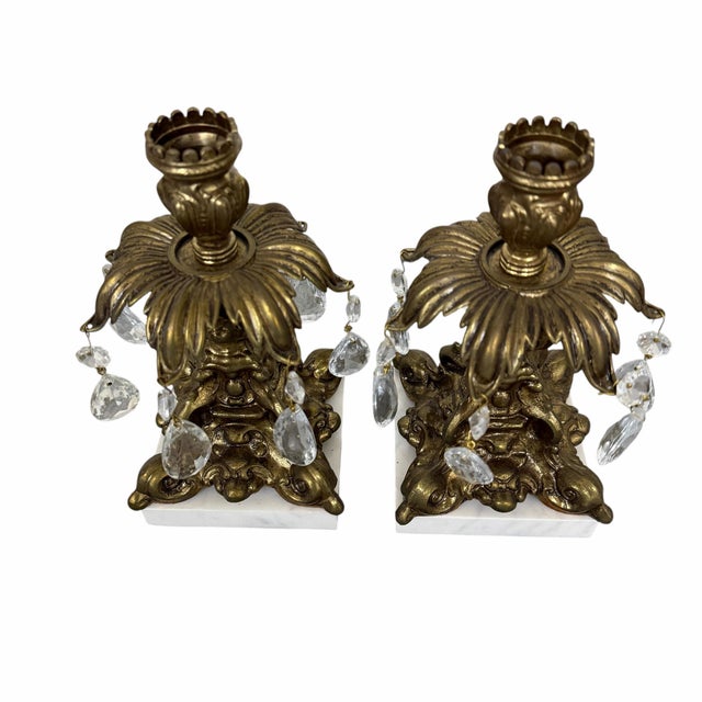 Vintage mid century Hollywood regency candlestick holders. Each holds seven hanging glass prisms Works with a standard...
