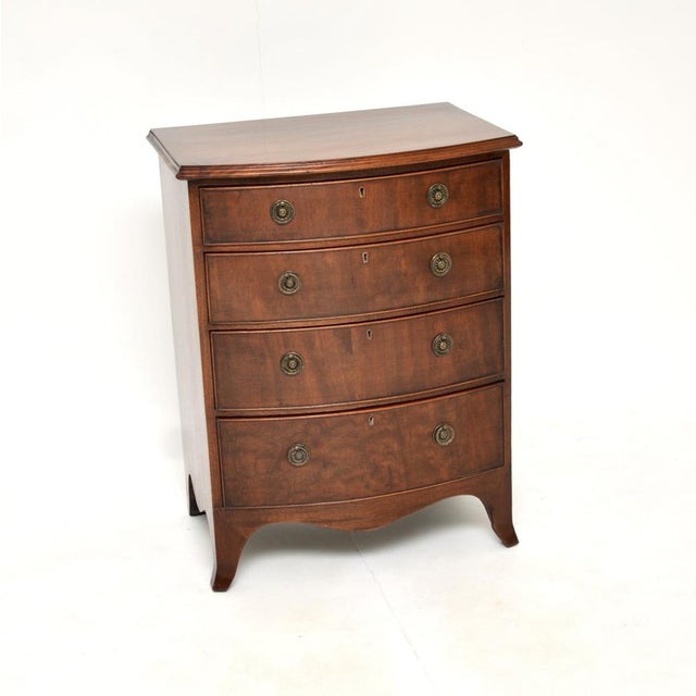 A very small and fine quality antique Edwardian bow fronted chest of drawers. This was made in England, it dates from...