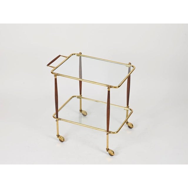 Spectacular and unique italian bar trolley in solid wood and brass. This incredibly stylish piece was designed by cesare...