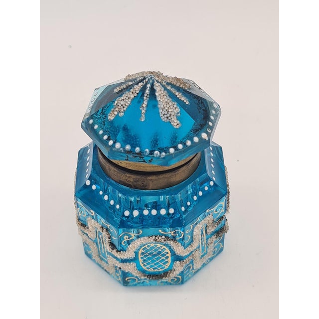 An elegant and exceptionally decorative antique inkwell made of faceted, deep blue glass, most likely from France, dating...