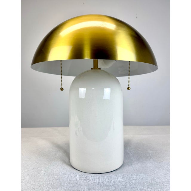 A fabulous minimalist meets mid century 2-light table lamp by Mitzi/Hudson Valley Lighting featuring off-white ceramic...