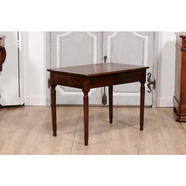 An Italian walnut side table from circa 1890 with elm star marquetry, single drawer and turned legs. This Italian walnut...