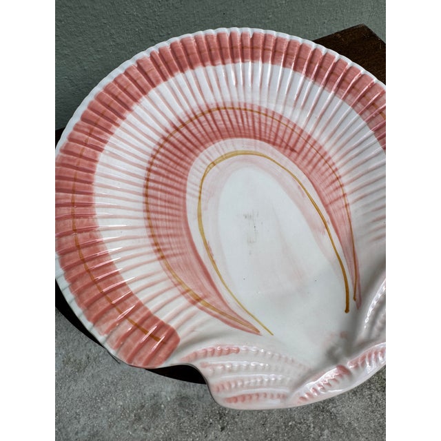 A beautifully crafted scallop shell-form ceramic dish by Fitz and Floyd, rendered in soft blush pink and white with...