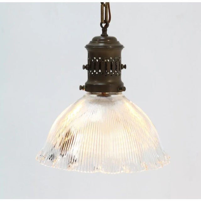 Wonderful Art Deco Holophane pendant lamp. Striking French design from the 1940s. Brass pendant and chain with original...