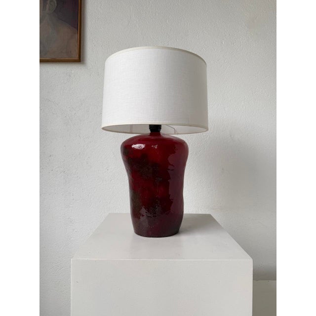 Old table lamp or desk lamp in red ceramic with its brown gradient in places from the 70s. Beautiful texture of ceramics....