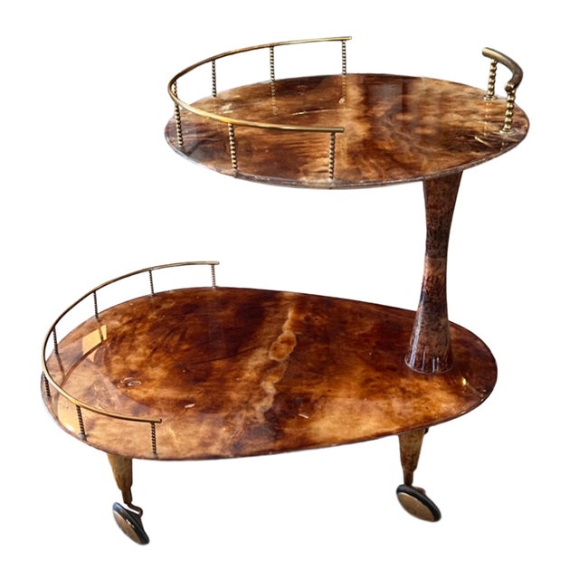 This wonderful lacquered goatskin and brass mid century drinks trolley was designed in Italy attributed to Aldo Tura. His...