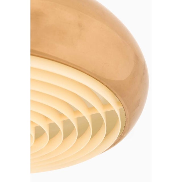 This ceiling lamp, attributed to an unknown designer and likely produced by Bergboms in Sweden, is a refined example of...