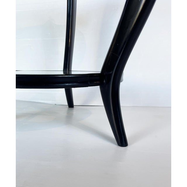 Elegant round coffee table from the 1950s, attributable to Paolo Buffa (1903-1970), made entirely of ebonized beech with...